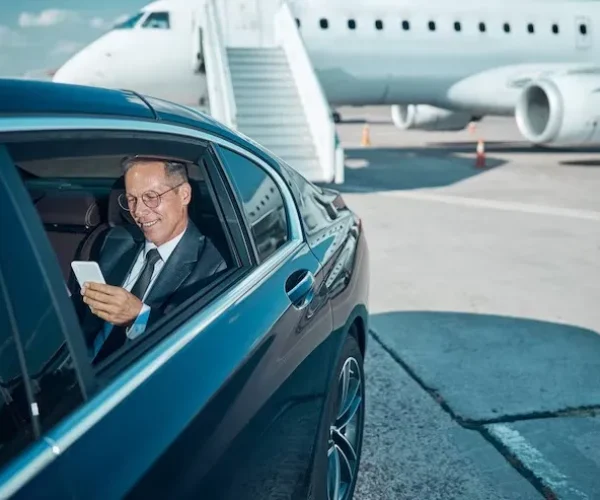 imgi_103_smiling-elegant-man-glasses-is-using-cell-phone-transfer-after-trip-by-plane_447912-6263